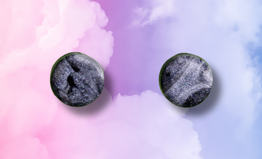 Round earrings with a black and white pattern on a colorful watercolor background