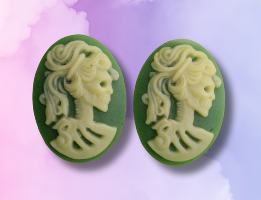Green cameo earrings on a colorful watercolor background